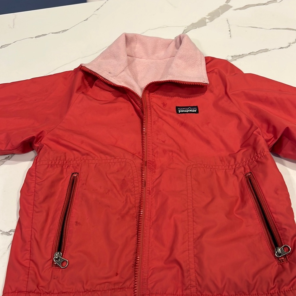 Light weight Patagonia jacket with fleece inside.